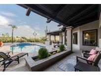 Inviting backyard oasis with a sparkling pool and covered patio at 9445 E Quail Trl, Carefree, AZ 85377