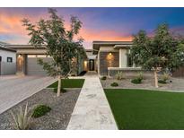 Modern home exterior with a landscaped yard and walkway at 9622 W Villa Chula Dr, Peoria, AZ 85383