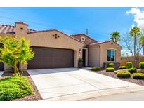 Tan two-car garage home with desert landscaping at 16953 W Merrell St, Goodyear, AZ 85395