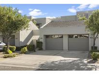 Attractive exterior of a townhome with a two-car garage at 7700 E Gainey Ranch Rd # 206, Scottsdale, AZ 85258