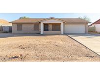 Single-story house with attached garage and desert landscaping at 12577 W Lobo Dr, Arizona City, AZ 85123