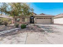 One-story house with tan exterior, stone accents, and a two-car garage at 2268 S 162Nd Ln, Goodyear, AZ 85338