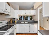 Kitchen with gray countertops, white cabinets, and dishwasher at 1601 N Saba St # 321, Chandler, AZ 85225