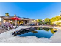 Relaxing pool area with patio furniture and lush landscaping at 1745 N 133Rd Dr, Goodyear, AZ 85395