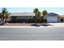 Brick ranch home with mature landscaping and a two-car garage at 12423 W Rock Springs Dr, Sun City West, AZ 85375