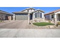 Stunning curb appeal with a two-car garage and landscaped yard at 34980 N Sacramento Wash Rd, San Tan Valley, AZ 85144