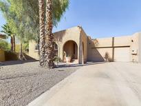 Charming single-story home with a gravel driveway and mature palm trees at 14679 N Love Ct, Fountain Hills, AZ 85268