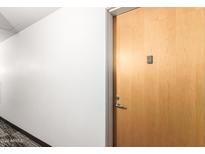 Apartment hallway with light walls and wood door at 7117 E Rancho Vista Dr # 2005, Scottsdale, AZ 85251