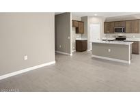 Modern kitchen with island and plenty of cabinet space at 1471 S 239Th Dr, Buckeye, AZ 85326