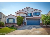 Two-story home with a blue garage door and landscaping at 775 E Leslie Ave, San Tan Valley, AZ 85140