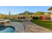 Landscaped backyard oasis with a pool, spa, and mountain views at 2554 N Tambor --, Mesa, AZ 85207