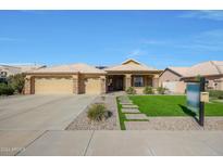 Beautiful single-story home with a two-car garage and manicured lawn at 13348 W Cambridge Ave, Goodyear, AZ 85395