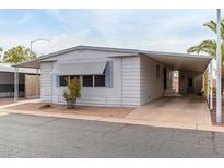 Single-wide manufactured home with carport and landscaping at 205 S Higley Rd # 288, Mesa, AZ 85206