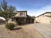 Two-story house with stone accents and a landscaped front yard at 2692 W Silver Streak Way, San Tan Valley, AZ 85144