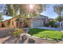 Two-story house with a landscaped yard and two-car garage at 44977 W Miraflores St, Maricopa, AZ 85139