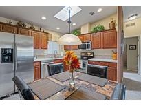 Eat-in kitchen with stainless steel appliances and wood cabinets at 3104 E Broadway Rd # 51, Mesa, AZ 85204