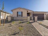 One-story home with brown garage door and stone accents at 4681 N 177Th Ln, Goodyear, AZ 85395