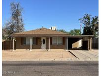 Ranch style home with front yard and carport at 3542 E Earll Dr, Phoenix, AZ 85018