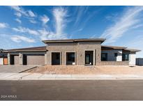Stunning modern home with stone accents and a three-car garage at 3823 W Lodge Dr, Laveen, AZ 85339