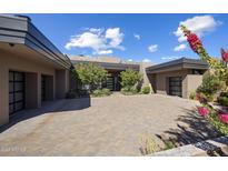 Stunning contemporary home with a large courtyard and two-car garage at 10284 E Running Deer Trl, Scottsdale, AZ 85262