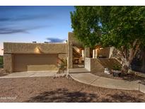 Tan stucco home with a covered entryway and garage at 6159 S Avenida Del Sol --, Gold Canyon, AZ 85118