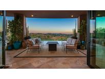 Covered patio with stunning sunset views and comfortable seating at 9719 E Madera Dr, Scottsdale, AZ 85262