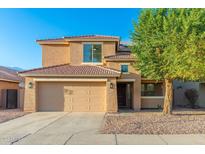 Two story house with double garage and desert landscaping at 8810 W Toronto Way, Tolleson, AZ 85353