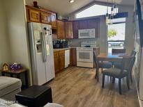 Bright kitchen with wood cabinets and dining area at 7750 E Broadway Rd # 761, Mesa, AZ 85208