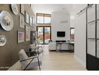 Bright living room with hardwood floors, fireplace, and large windows at 6525 E Cave Creek Rd # 6, Cave Creek, AZ 85331
