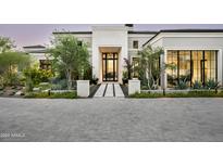 Stunning curb appeal with a grand entrance, landscaped grounds, and paved driveway at 20958 N 112Th St, Scottsdale, AZ 85255