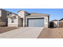 Single-story home with a gray garage door and stone accents at 7422 W Whitehorn Trl, Peoria, AZ 85383