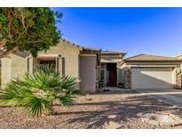 One-story home with desert landscaping, stone accents, and a two-car garage at 13506 W Earll Dr, Avondale, AZ 85392