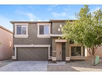 Two-story house with attached garage and landscaping at 409 E Saddle Way, San Tan Valley, AZ 85143