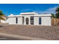 White single story home with a rock front yard at 319 S 84Th Way, Mesa, AZ 85208