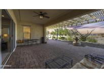 Covered patio with brick flooring and fountain at 27552 W Tonopah Dr, Buckeye, AZ 85396