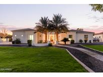 Luxury home with palm trees and a walkway at 22474 S 199Th Cir, Queen Creek, AZ 85142