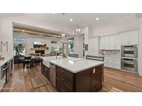Spacious kitchen with large island, stainless steel appliances, and white cabinets at 6429 S Honor Ct, Gilbert, AZ 85298