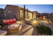 Peaceful backyard oasis with fire pit, pool, and mountain views at 13051 N 145Th Way, Scottsdale, AZ 85259