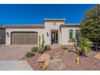 House exterior featuring a two-car garage and desert landscaping at 168 E Alcatara Ave, San Tan Valley, AZ 85140