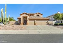 Two-story house with a three-car garage and desert landscaping at 19435 N 62Nd Ave, Glendale, AZ 85308