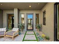 Modern entryway with glass door and lush plants at 37200 N Cave Creek Rd # 1126, Scottsdale, AZ 85262