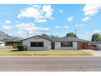 Mid-century modern home with landscaped yard and mountain view at 1455 E Tuckey Ln, Phoenix, AZ 85014