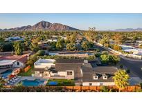 Aerial view of a remodeled mid-century modern home with pool and mountain views at 3014 N 61St Pl, Scottsdale, AZ 85251