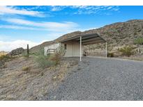 Single-wide manufactured home on a mountain lot at 52320 W Foothill Trl, Maricopa, AZ 85139