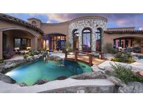 Luxury estate with inviting pool and spa, surrounded by lush landscaping at 9808 E Honey Mesquite Dr, Scottsdale, AZ 85262