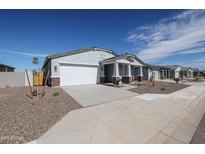 New single-story home with white garage door and brick accents at 35560 W La Paz St, Maricopa, AZ 85138
