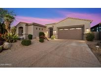 Single-story home with desert landscaping and two-car garage at 34599 N 99Th Way, Scottsdale, AZ 85262