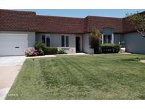 Attractive condo with brown roof, attached garage, and neatly landscaped front yard at 3114 E Hazelwood St, Phoenix, AZ 85016