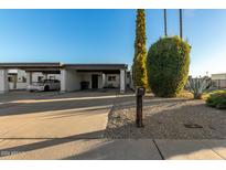 Single-story home with carport and desert landscaping at 3017 W Hearn Rd, Phoenix, AZ 85053