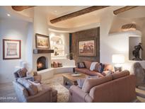 Living room with a cozy fireplace and natural light at 9215 E Red Lawrence Dr, Scottsdale, AZ 85262